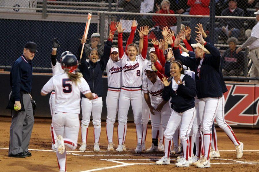 Arizona softball utility Hallie Wilson (5) runs home to her teammates after hitting her first home run of the season during Arizonas 6-1 win against Drake during the opening game of the Hillenbrand Invitational at Hillenbrand Stadium on Thursday. Wilson and the Wildcats have five more games over the weekend. 