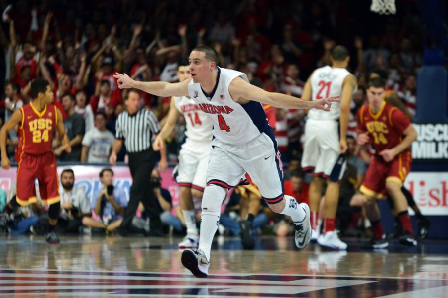 Arizona mens basketball guard T.J. McConnell (4) makes the JET motion to honor former Arizona basketball player Jason Terry during Arizonas 87-57 win against USC in McKale Center on Thursday. McConnell and the Wildcats won their third-straight game and face UCLA on Saturday. 