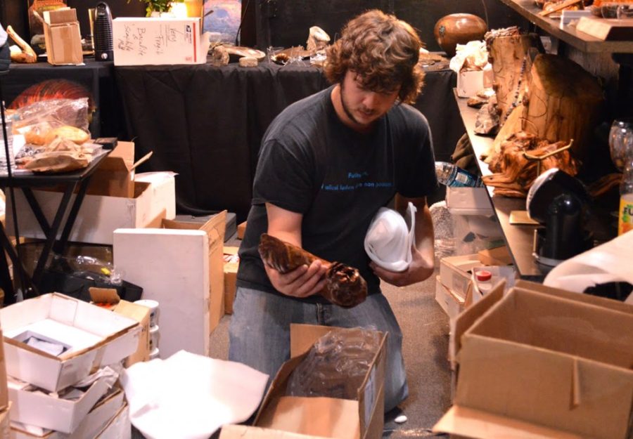 Luke Larson packs away ammonites to take back home to South Dakota on Sunday at the Mineral & Fossil Cooperative. Larson said this year marked his 10th year at the show and is the largest source of revenue for his family business.