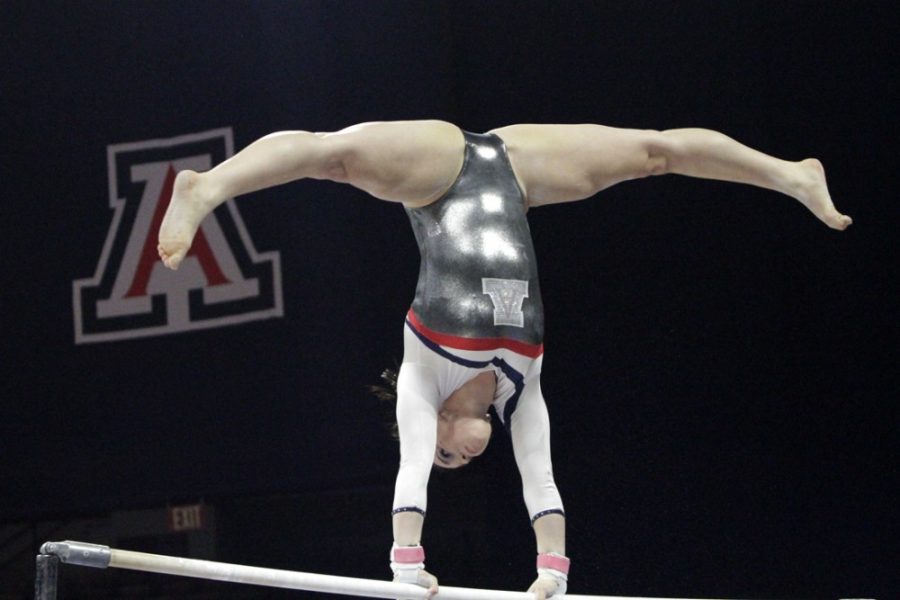 Arizona gymnast Victoria Ortiz performs on the bars during Arizonas season-high 196.625-195.375 win against ASU in McKale Center on Monday. Ortiz has helped Arizona climb up the rankings to No. 17 overall in the nation on bars.