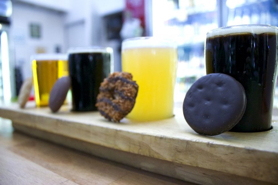 Four Girl Scout cookies lean against their complementary beer flights. Tap & Bottle hosted a cookie and beer pairing on Sunday in honor of Girl Scout cookie season.