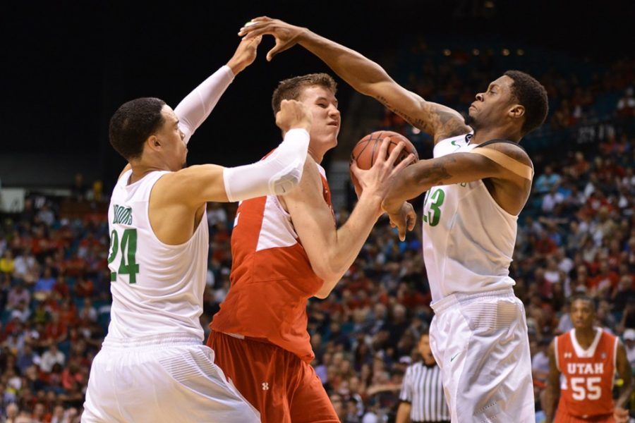 Oregon forwards Dillon Brooks (24) and Elgin Cook (23) defend Utah forward Jakob Poeltl (42) during Oregons 67-64 win against Utah in the semi-finals of the Pac-12 Tournament in the MGM Grand Garden Arena in Las Vegas, Nev. on Friday night.