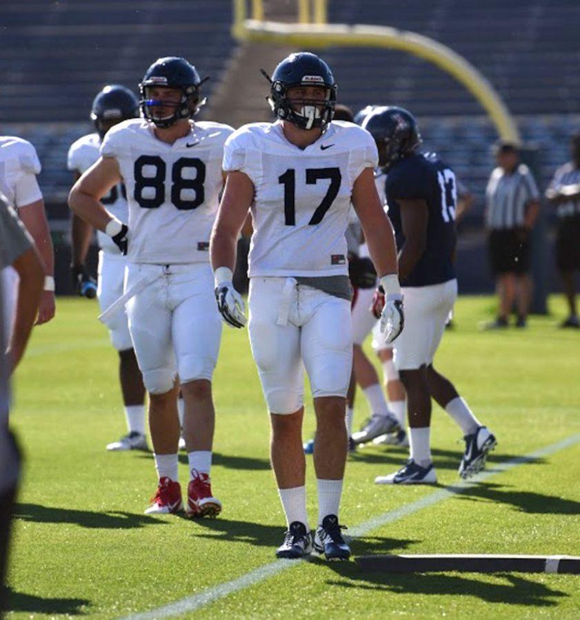 Arizona football tight ends Trevor Wood (88) and Josh Kern (17) take a breather during Arizonas football practice on Monday at Kindall Field at Frank Sancet Stadium. Arizona football coach Rich Rodriguez said he envisions tight ends getting more reps this spring in preparation for next season.