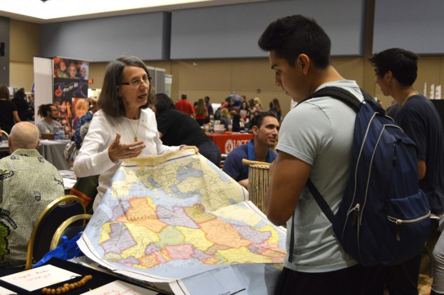 Cathy Della Penta, returned Peace Coprs volunteer who served in Niger and Senegal, points out the region where she served on a map during the ninth annual Peace Corps Fair in the Student Union Memorial Center on Friday. The Peace Corps Fair included booths for more than 50 countries where the Peace Corps is active.