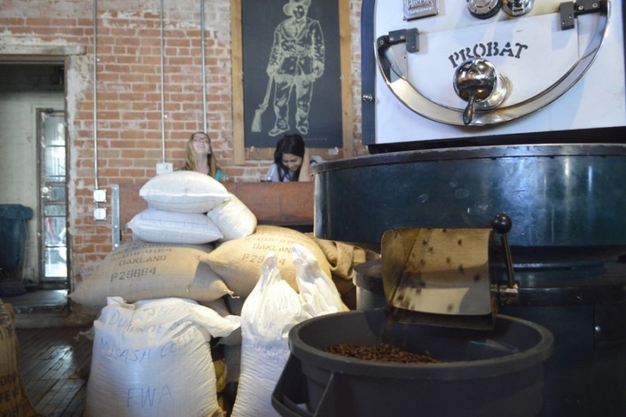 Coffee beans pour out of the roaster at Exo Roast Company on Thursday. The coffee shop takes care in selecting and roasting beans to make the perfect cup of cof