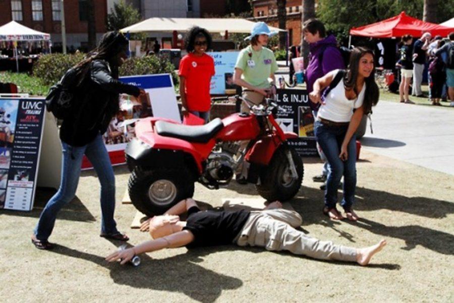 File photo / The Daily WildcatStudents practice safety techniques with a dummy on the UA Mall during the Spring Break Safety Fair in February 2013. More participants and informational booths will be present at the fair this year than previously.