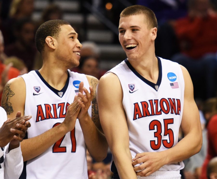 Arizona mens basketball forward Brandon Ashley (21) and Arizona center Kaleb Tarczewski (35) laugh together once their 73-58 win against Ohio State became imminent in the final minutes of gameplay in the Moda Center in Portland, Ore., on Saturday. With top-rated teams in the West Region falling and dominant play continuing, things are falling into place for Arizona.