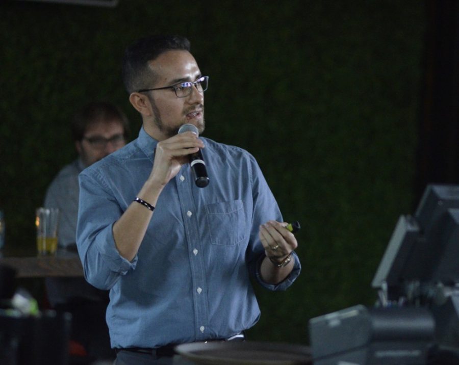 Edward Polanco, a history graduate student, presents his research at the Playground Bar and Lounge in Tucson on Wednesday. The UA Confluencenter for Creative Inquiry hosted the event, where two graduate students and one Ph.D. candidate spoke.