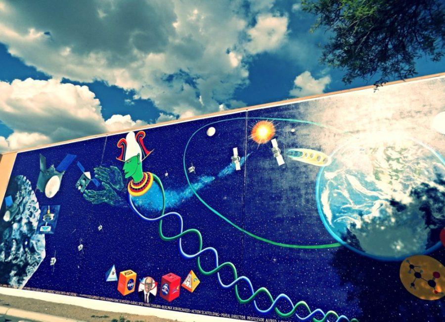 Lunar+and+Planetary+Lab+and+UA+art+students%2C+led+by+Alfred+Quiroz%2C+a+UA+professor+of+art%2C+collaborated+to+create+a+mural.+It+is+meant+to+commemorate+the+OSIRIS-REx+mission%2C+and+is+on+display+on+the+west+side+of+the+Michael+J.+Drake+building.