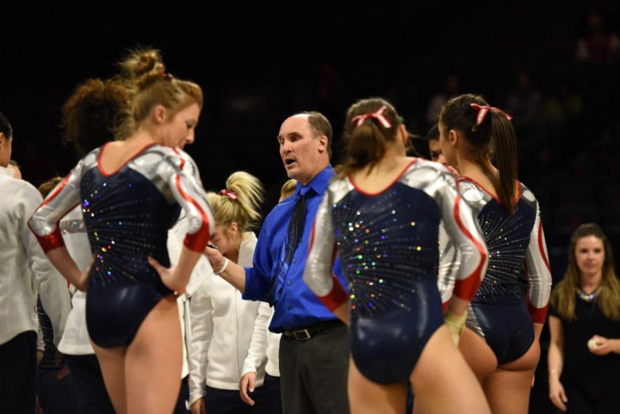 Arizona gymnastics coach Bill Ryden speaks with team members during Arizonas 196.850-196.850 tie with Denver on March 14 in McKale Center. Ryden stepped down from the program last week and will be remembered as a tough but loving leader.