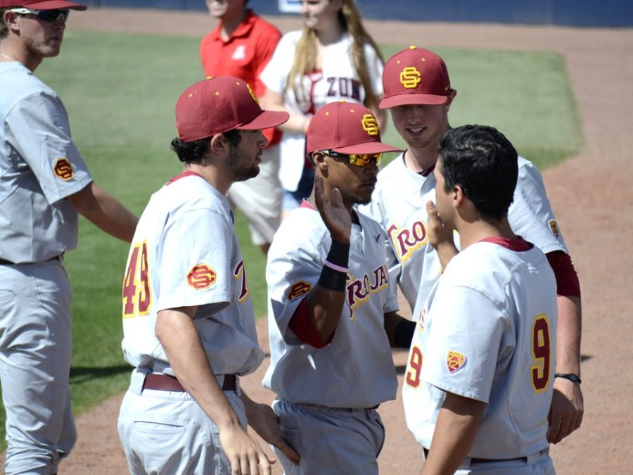 Members+of+the+USC+baseball+team+high-five+during+their+10-9+victory+over+Arizona+at+Hi+Corbett+Field+on+Saturday.+USC+overtook+UCLA+for+the+top+spot+in+the+Pac-12+power+rankings.