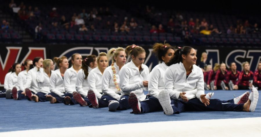 The Arizona gymnastics team waits for results at the end of Arizonas 196.850-196.850 tie with Denver in McKale Center on March 14. Arizona plays in its 29th consecutive NCAA regional action over the weekend.