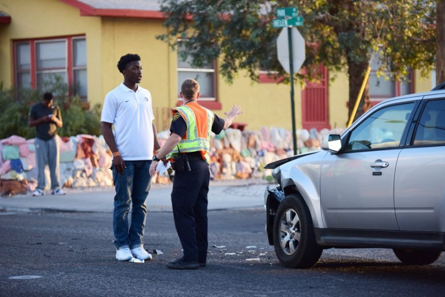 Stanley Johnson speaks with Tucson Police Officer Swaton at the scene his car collision on the corner of Helen Street and Park Avenue on Thursday evening.