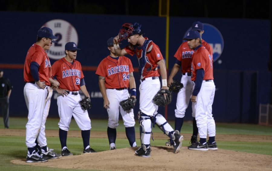Members of the Arizonas baseball team meet at the mound with Arizona coach Andy Lopez (7) during Arizonas 6-5 loss to Arizona State on Wednesday at Hi Corbett Field. The Wildcats saw their 4-0 lead evaporate quickly.