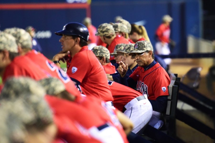 Coach Andy Lopez signals from the dugout during Arizonas 2-1 win against Hawaii at Hi Corbett Field on Saturday night.