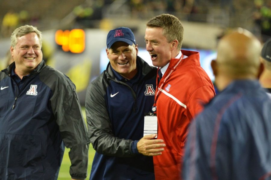 Arizona football coach Rich Rodriguez and athletic director Greg Byrne celebrate together after Arizonas surprising 31-24 win against Oregon in Autzen Stadium in Eugene, Ore., on Oct. 2, 2014. The Wildcats upset then-No. 5 Oregon to provide the seasons signature win.