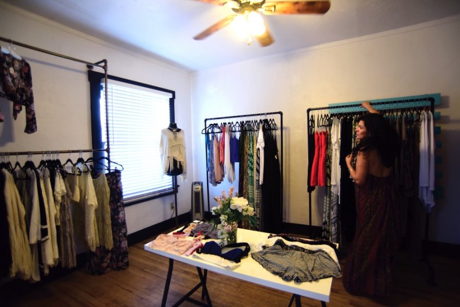 Zulema Toledo organizes clothing at ZT Boutique on 4th Avenue on Sunday. ZT Boutique carries “effortless and unique clothes” for women.