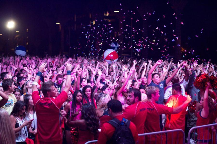 University of Arizona students dance and wave to music by Hot Dub Time Machine on the UA mall at New Student Convocation on Sunday, August 23, 2015. The concert was forced to end early due to rain.