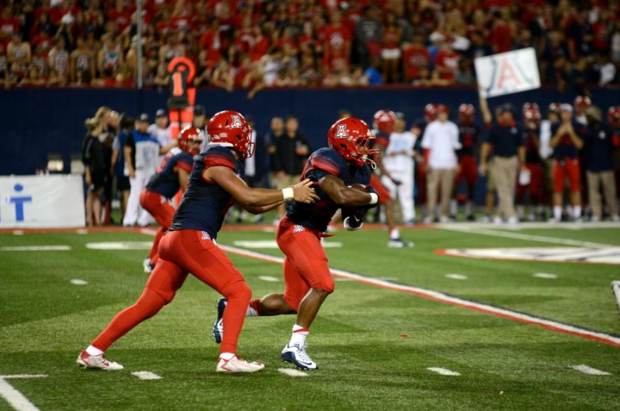 <p>Anu Solomon (12) hands the ball to Jared Baker (23) during the Sept. 3 game against UTSA. Solomon threw four touchdowns en route to a 42-32 victory.</p>