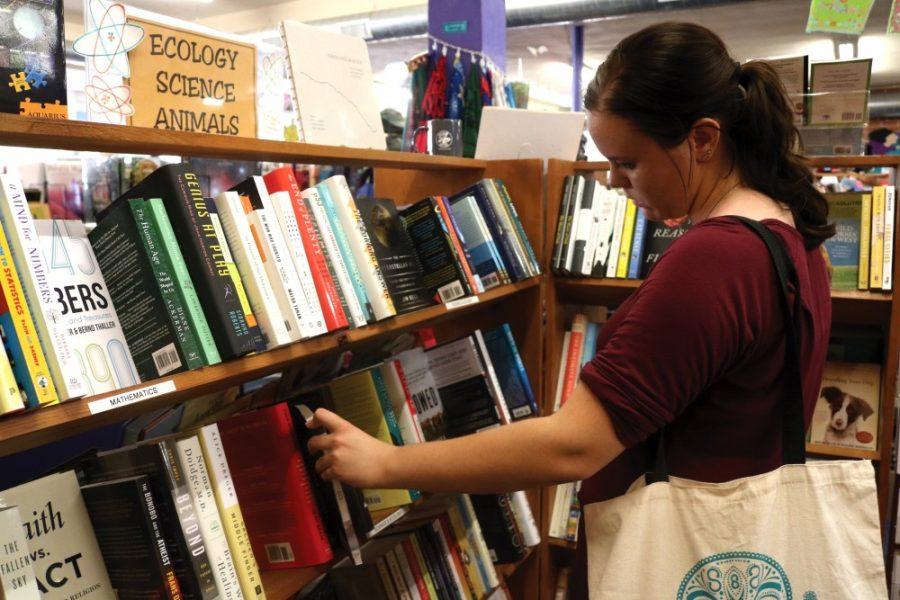 Rebecca Reiter, a sophomore studying special education and rehabilitation, looks for the perfect book to de-stress with at Antigone Books on Fourth Avenue on Wednesday, Sept. 16. Antigone Books has an open atmosphere featuring a sitting area and book clubs.