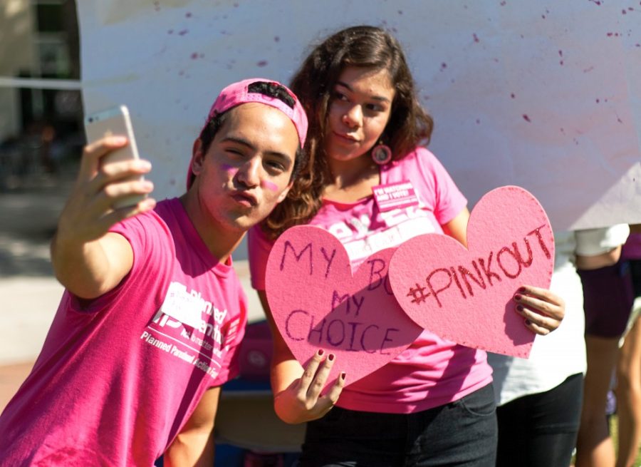 Alex Ross, vice president of VOX: Voices for Planned Parenthood, takes a selfie with Anna Keene, president of VOX, at their Pink Out event on the UA Mall on Tuesday, Sept. 29. Pink Out was a nationwide event to stand in solidarity with Planned Parenthood.