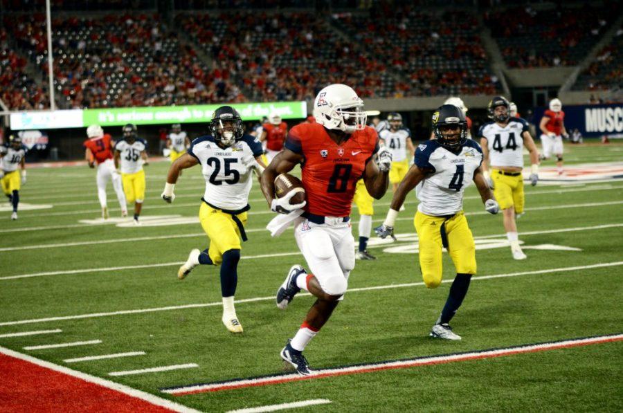 <p>Quarterback Jerrard Randall (8) runs down the field with the ball. The Wildcats defeated the Lumberjacks 77-13.</p>