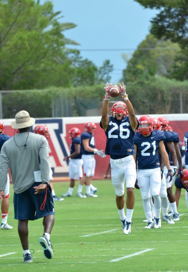Arizona safety Nick Fadelli jumps for a catch while running a drill at practice on Sunday, Aug. 30.