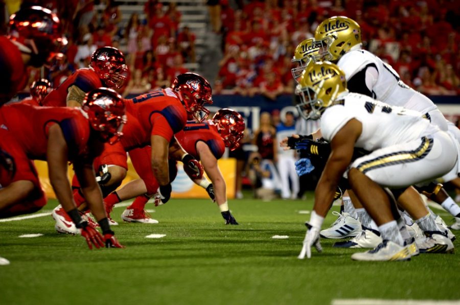 The+defensive+line+prepares+for+a+play+from+UCLA+at+Arizona+Stadium+on+Saturday%2C+Sept.+26.+The+Wildcats+were+defeated+by+the+Bruins+56-30.