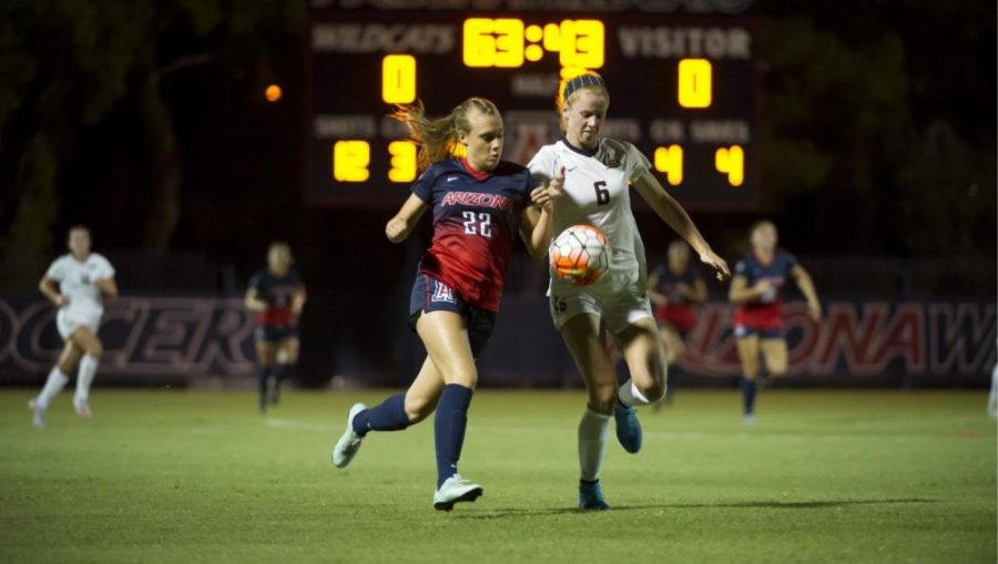 <p>Defense player Jessica Nelson (22) vies for the ball on Friday, Oct. 16. Photo Courtesy of Arizona Athletics</p>