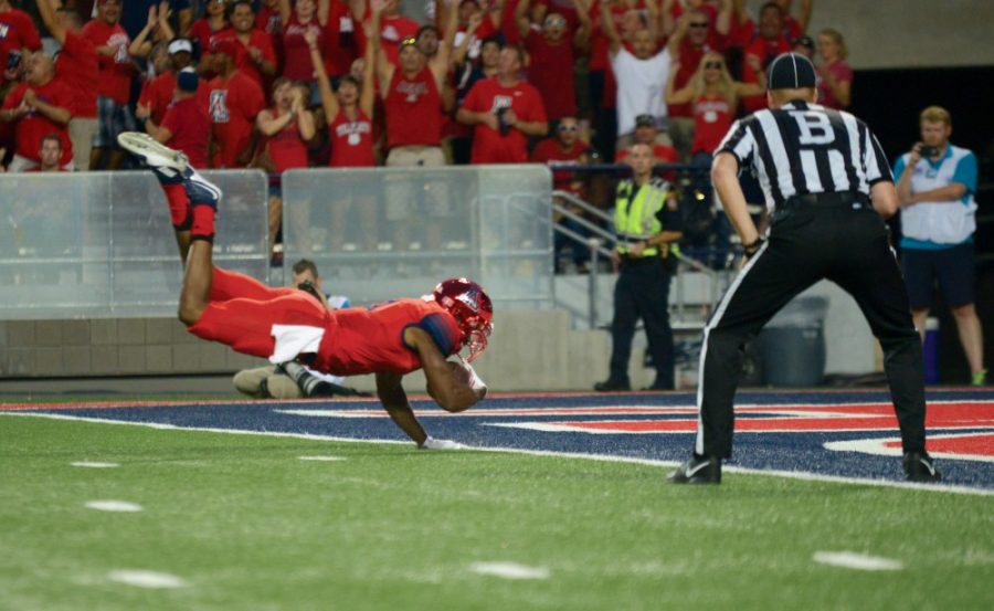 Arizona+quarterback+Jerrard+Randall+%288%29+dives+into+the+endzone+for+a+touchdown+against+UCLA+on+Saturday%2C+Sept.+26.