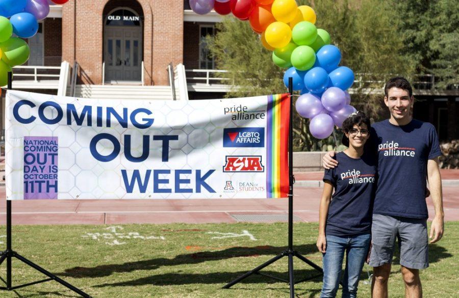 Mary Knudson, left, and Jacob Winkelman, right, co-directors of ASUA Pride Alliance, pose for a photo at the Coming Out Week Resource Fair on the UA Mall on Wednesday, Oct. 7.