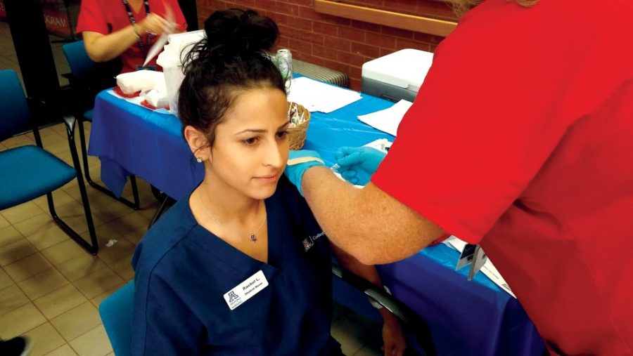 Rachel Lima, a second-semester UA nursing student, receives a flu vaccine during the on-campus flu shot clinic hosted by Campus Health Service on Sept. 29. UA nursing students are required to receive influenza vaccines once a year to help keep them and their patients safe during their clinical rotations at hospitals throughout Tucson.