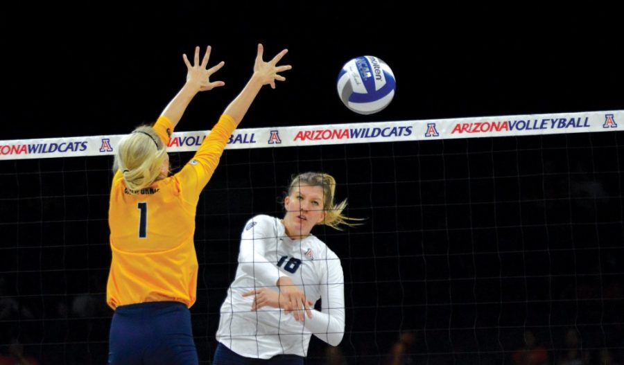 Arizona middle blocker McKenzie Jacobson (18) spikes against California on Oct. 2 in McKale Center. Jacobson has stressed the importance of working together to knock off top-ranked opponents.