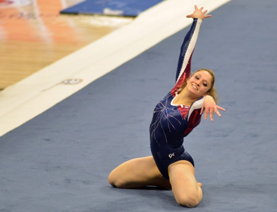 Then-junior Arizona gymnast Jessie Sisler strikes a pose during her floor routine in McKale Center on Jan. 16.