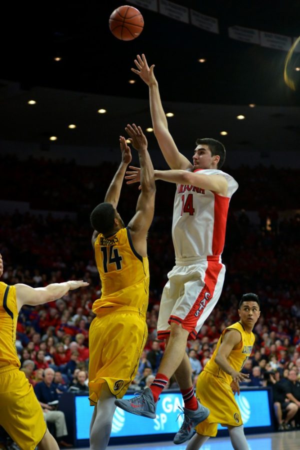<p>Arizona center Dusan Ristic (14) shoots against Cal on Sunday, March 5, in McKale Center. The Golden Bears are ranked No. 14 in the Associated Press Top 25 preseason rankings, while Arizona sits at No. 12.</p>