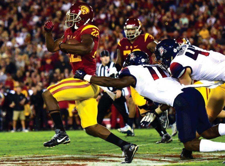 USC running back Justin Davis (22) evades safety Will Parks (11) and linebacker Jake Matthews (47) at the Los Angeles Memorial Coliseum on Saturday, Nov. 7. Davis burned the Wildcats defense for 85 yards and two touchdowns in Arizonas 38-30 loss.