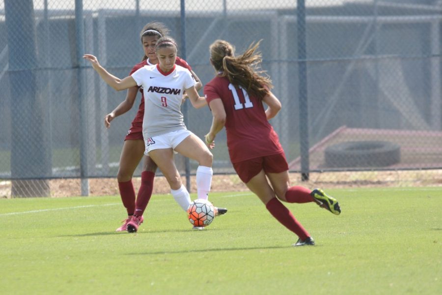 <p>Arizona midfielder Gabi Stoian (9) defends the ball from two Stanford opponents on Oct. 4. Stoian has missed four games because of injury but returned to practice ahead of the Wildcats' second round NCAA Tournament game this week.</p>