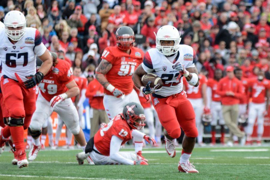 Arizona running back Jared Baker (23) slips past the New Mexico defense  on his way to a touchdown early in the second quarter of the Gildan New  Mexico Bowl at University Stadium in Albuquerque, New Mexico on  Saturday, Dec. 19.