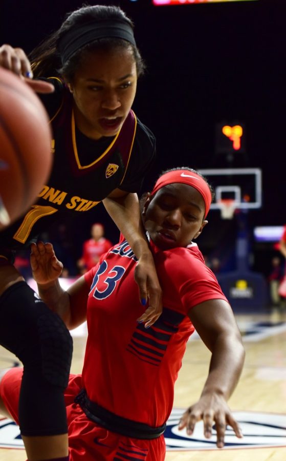 ASU guard Arnecia Hawkins (1) navigates past Arizona guard JaLea Bennett (33) during ASUs 62-47 win over Arizona on Sunday, Jan. 24 in McKale Center. The Wildcats dropped to a 11-9 record overall on the season. 