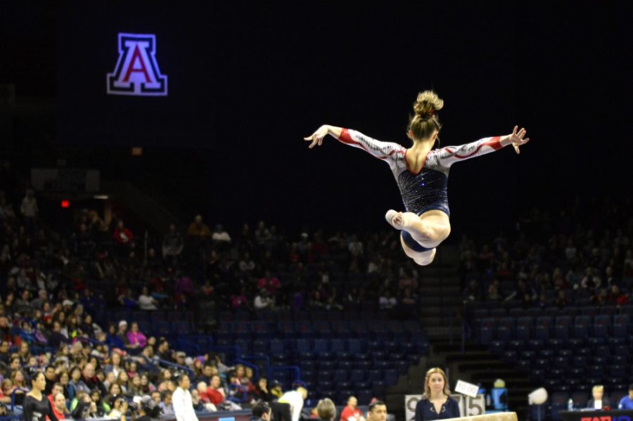 An Arizona gymnast jumps high in the air in McKale Center on Friday, Jan. 8. The Wildcats have impressed early with a young team and have an overall record of 2-1. 
