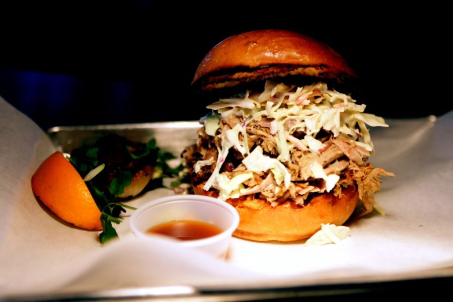 A+fresh+pulled-pork+sandwhich+being+prepared+for+serving+at+Reds+Smokehouse+and+Tap+Room+on+Thursday.