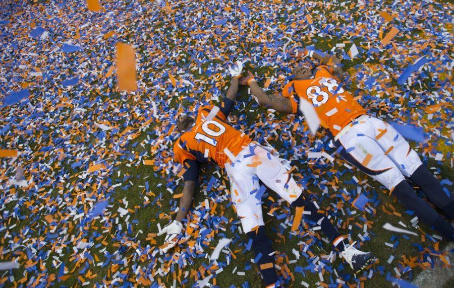 Broncos wide receivers Emmanuel Sanders and Demaryius Thomas make angels in the confetti following Denvers 20-18 win in the AFC Championship game against the New England Patriots on Sunday, Jan. 24, 2016, at Sports Authority Field at Mile High in Denver. (Mark Reis/Colorado Springs Gazette/TNS)