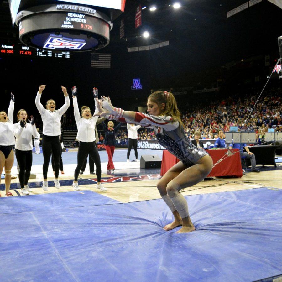 Arizona gymnast Lexi Mills lands her jump off the high beams in McKale Center on Friday, Jan. 8. The Texas native is one of four senior leaders on this years team.