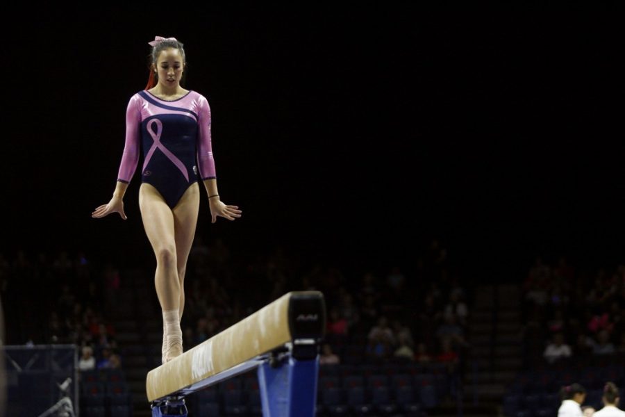 Arizona gymnast Shelby Edwards prepares to execute her beam routine in McKale Center on Saturday, Feb. 27. Edwards coined the term gritty kind of pretty to describe the life of a collegiate gymnast. 
