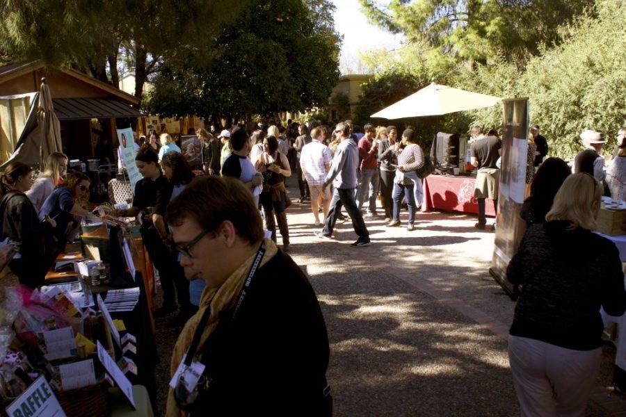 People walk around the stalls of the Savor Food and Wine Festival in Tucson on Saturday, Feb. 6. The Southern Arizona Arts and Cultural Alliance hosted a menu and alcohol-tasting event.
