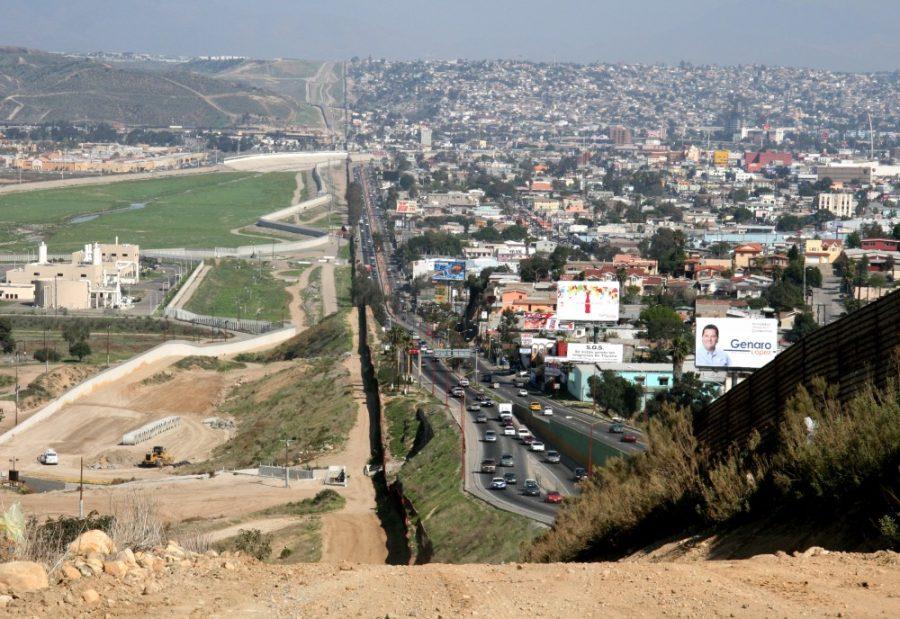 A small fence separates densely-populated Tijuana, Mexico, (right) from the U.S. in the Border Patrols San Diego Sector. Tijuana is a popular place for UA students to vacation for spring break with beaches and good nightlife.