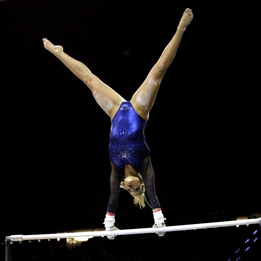 Arizona gymnast Gabrielle Laub swings on the uneven bars in McKale Center on Saturday, Feb. 13. The No. 20 Wildcats fell to No. 13 Stanford 196.65-196.15 and managed to hit all 24 of their routines. 