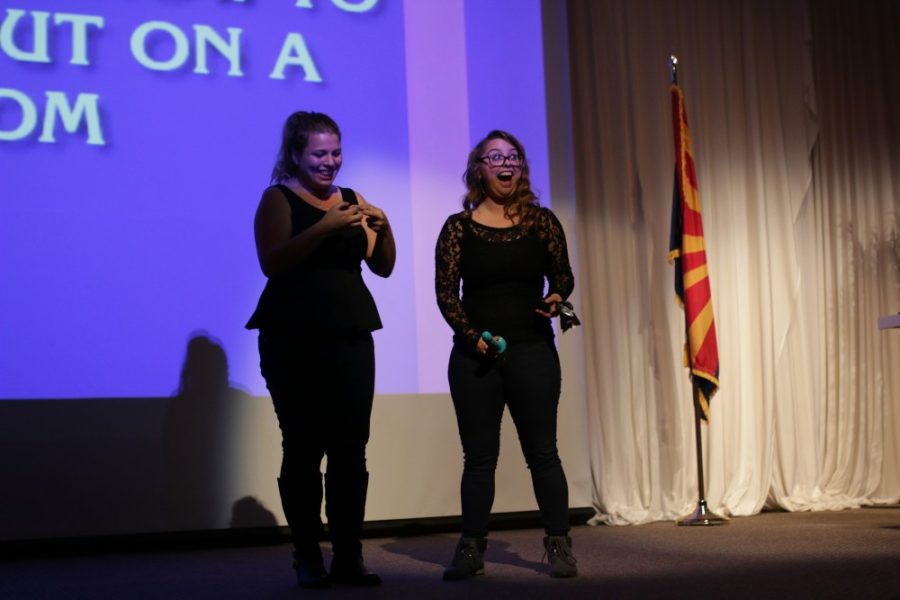 Laci Green and a volunteer stand on stage demonstrating with various props at the UA student union on Thursday, Feb. 4.