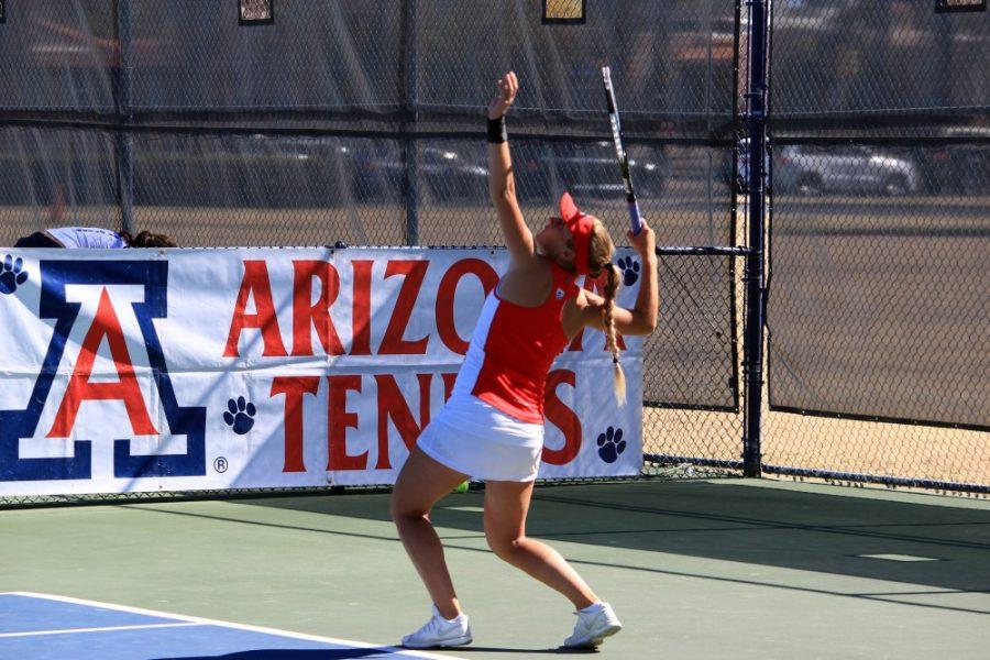 Arizona tennis athlete Shayne Austin serves the ball during UA Doubles Matches against University of San Diego. Austin and her teammate Lauren Marker sealed a crucial win with a final score of 6-4.