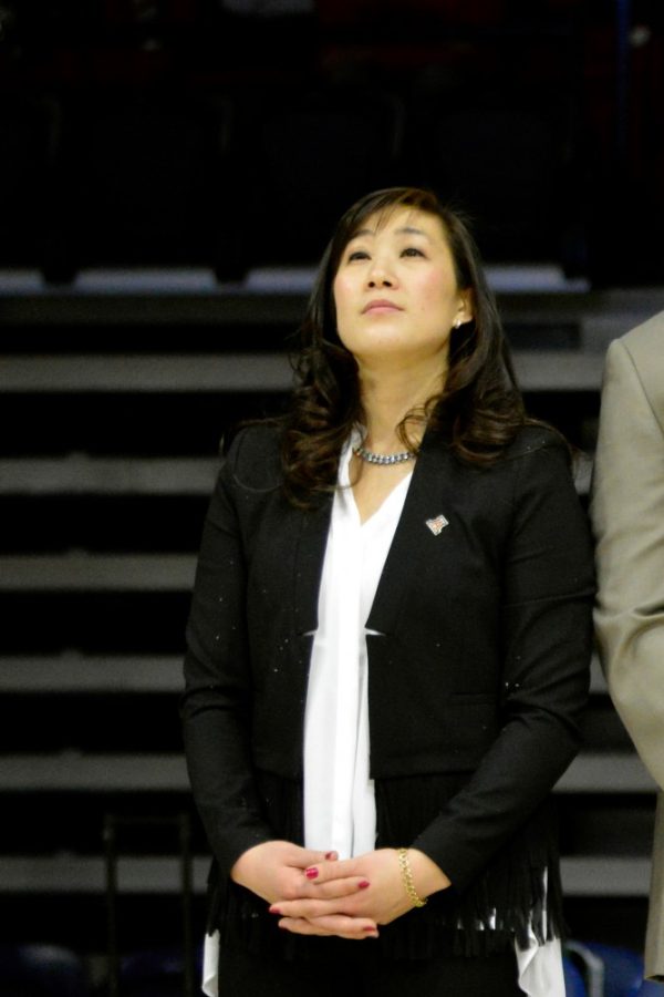 Arizona gymnastics head coach Tabitha Yim stands watching the screen in the center of McKale Center on Friday, Jan. 8. Yim will face her alma mater Stanford on Saturday, Feb. 12.